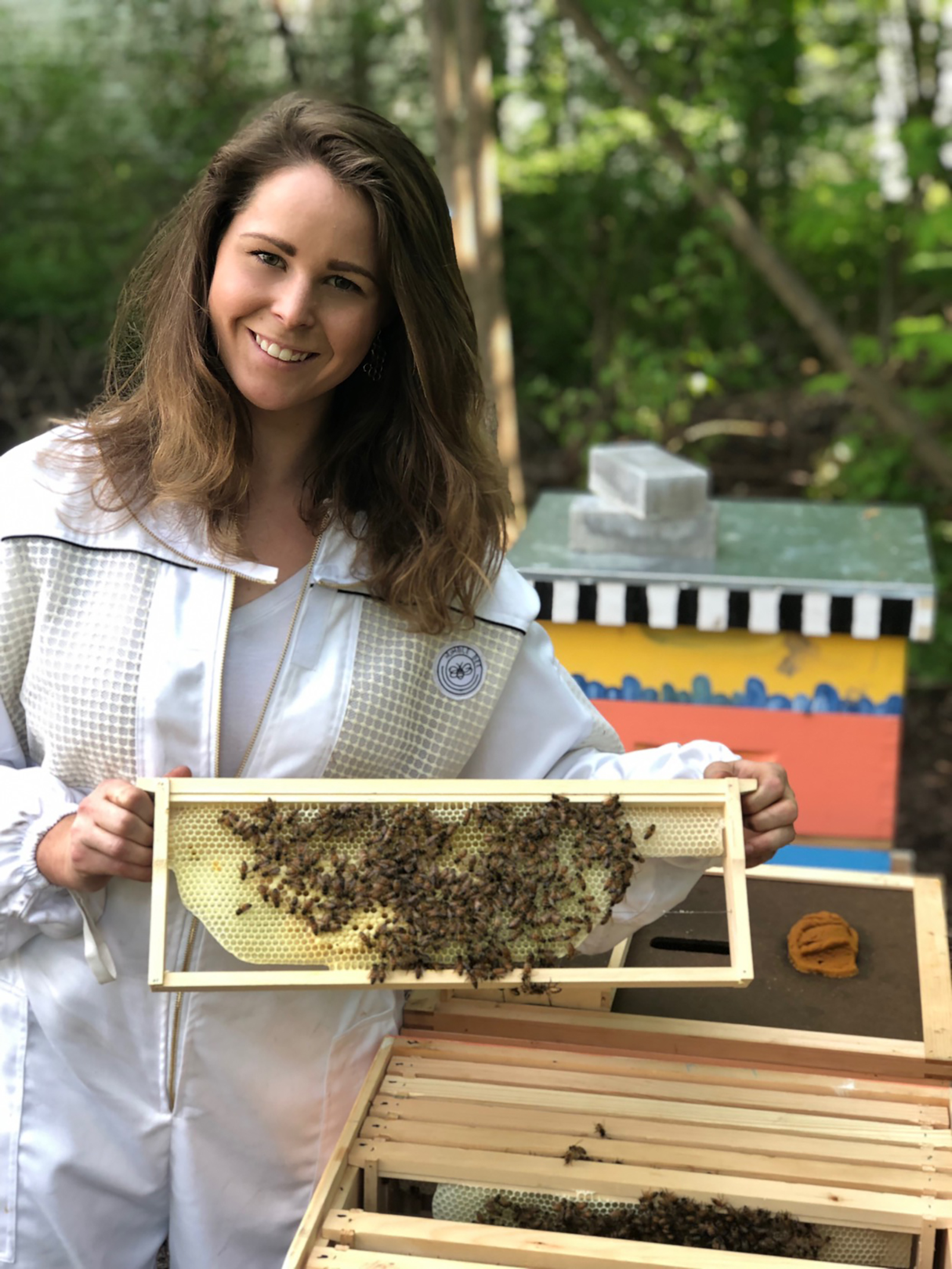 Ellen Brooks holding bee hive frame