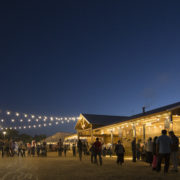 Festival goers walk around at night