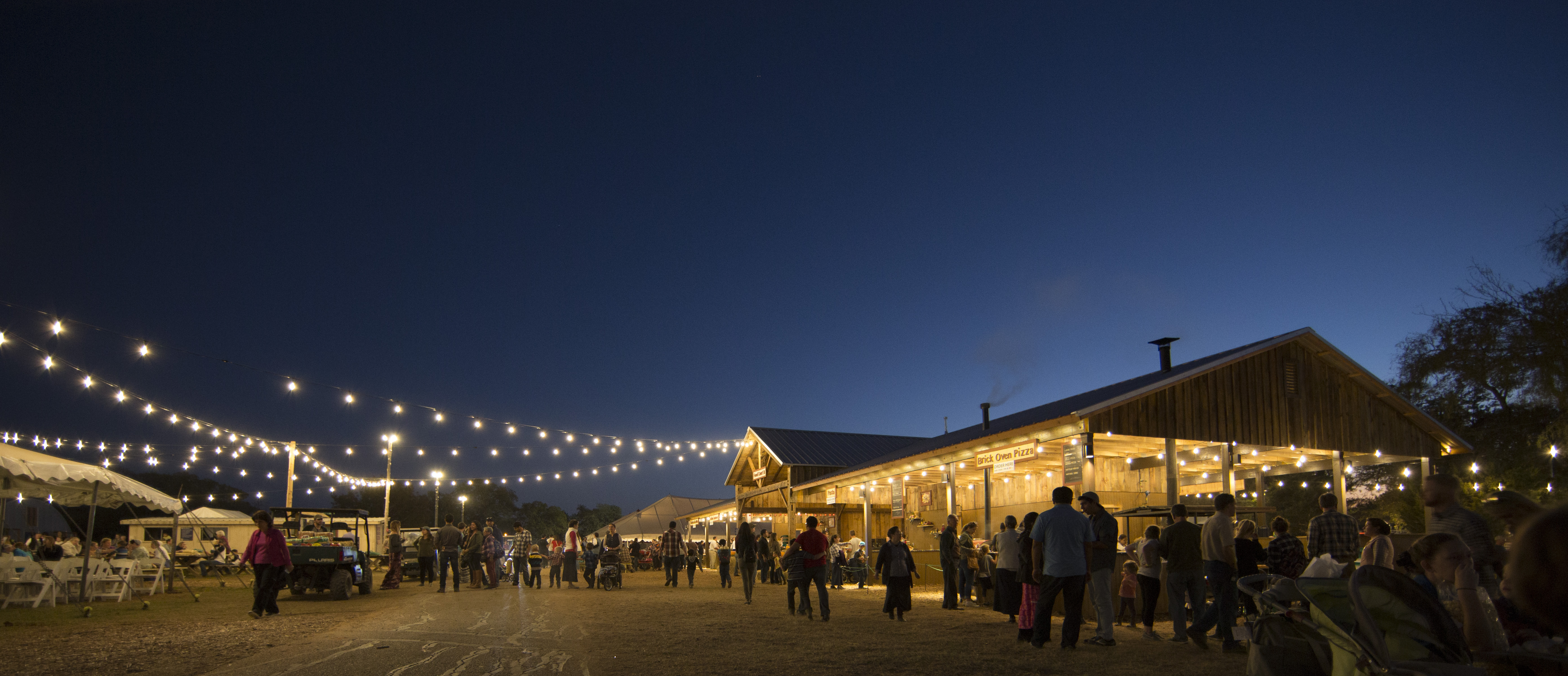 Festival goers walk around at night