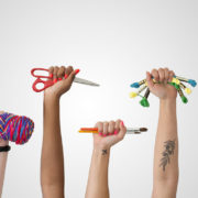 7 raised hands holding crafting gear